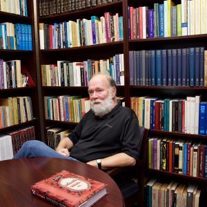 John Reeves is surrounded by the religious texts in his office library.