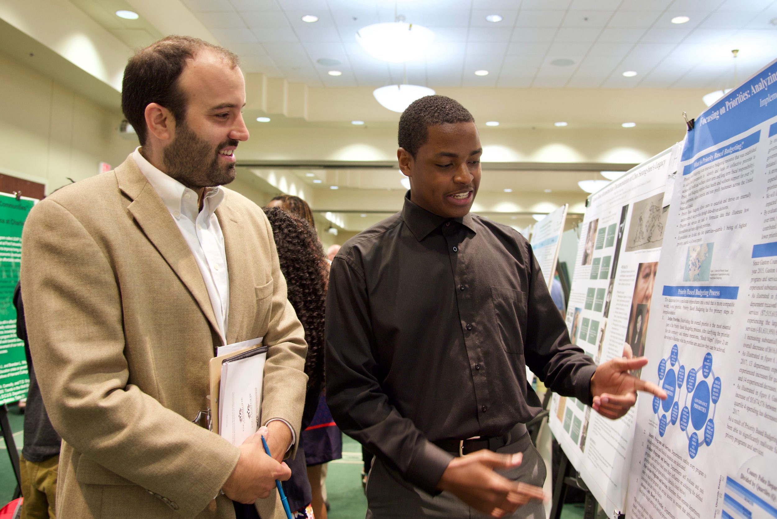 Faculty with student doing presentation