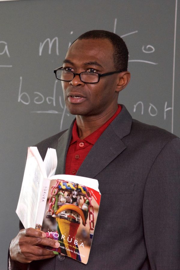 Ogundiran in class holding a book