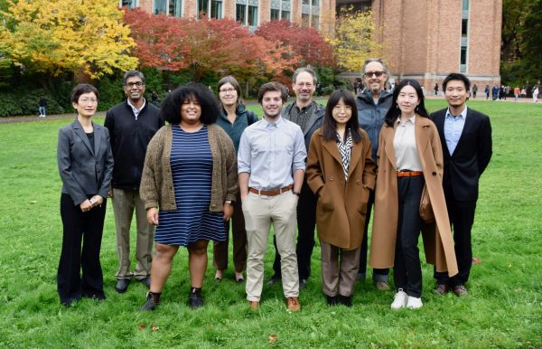 Team of researchers in two rows outside