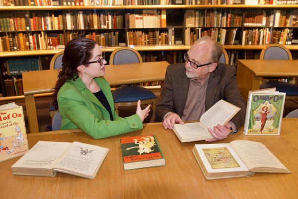 Dina Massachi and Mark West with Oz books on a table