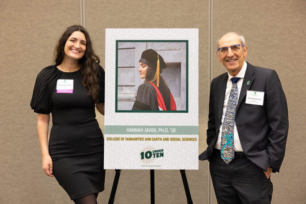 Hannah Javidi poses with her award poster and her father, Farhad Javidi