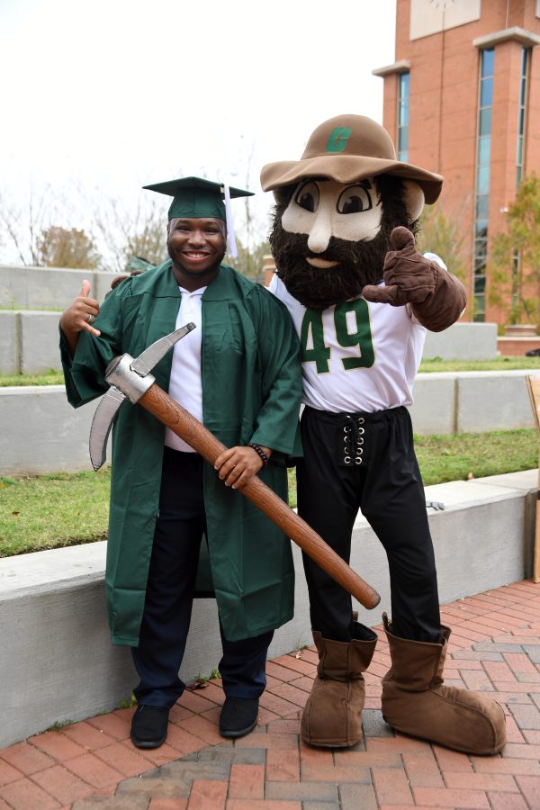 Jeremiah Morris in his cap and gown with Norm