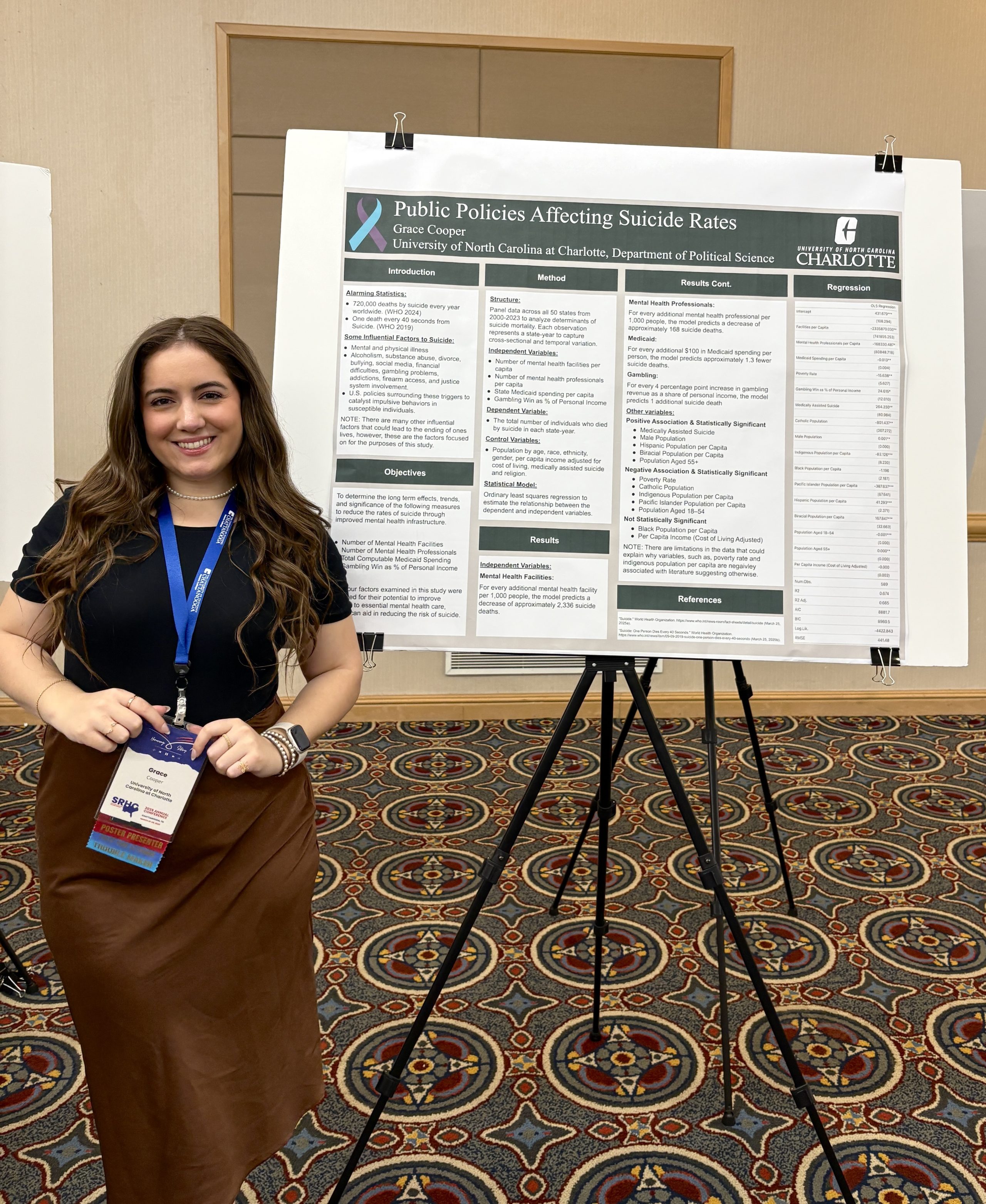 Grace Cooper stands in front of her research poster.