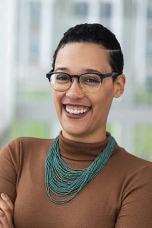 photo of Fuschcia Hoover with brown shirt and bluegreen necklace.