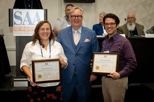 Sara Juengst (left) posing with the Presidential Recognition Award alongside president Christopher Dore (middle) and Matthew Velasco (right).