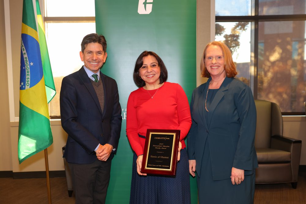 Al-Shamat poses with her award at the International Education Awards, alongside the provost and the 
