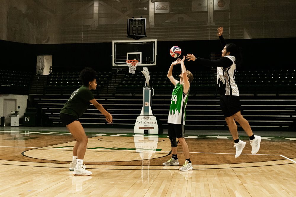 Madison Black in position on the court working with the men's club volleyball team.