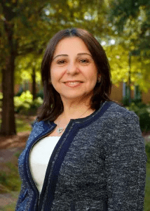 Hania al-Shamat headshot taken outside with trees in the background