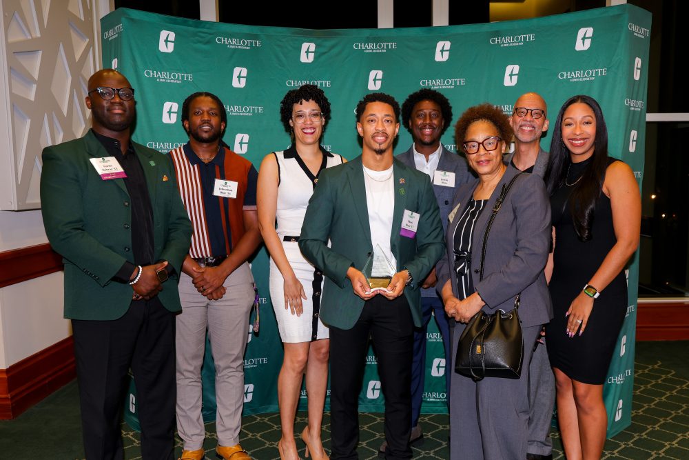 Nkosi Muse poses with family, friends and his former faculty members after receiving his award.