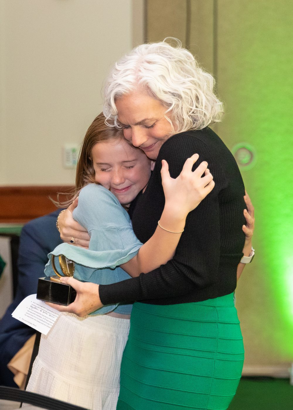 Laura Yates Clark hugs a young family member.