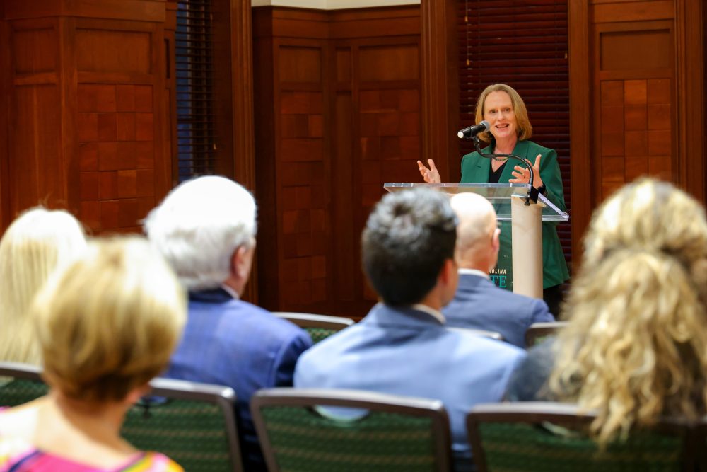 Provost Jenifer Troyer addresses the crowd from the podium