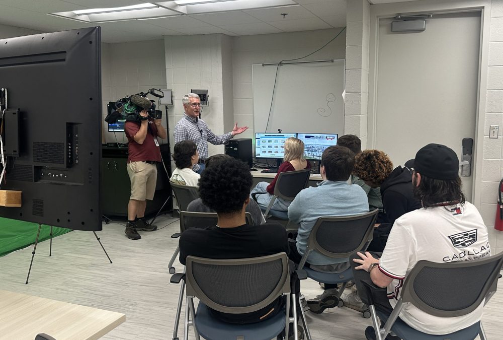 Steve Udelson speaks to students about the new weather computers while being recorded for WSOC-TV.