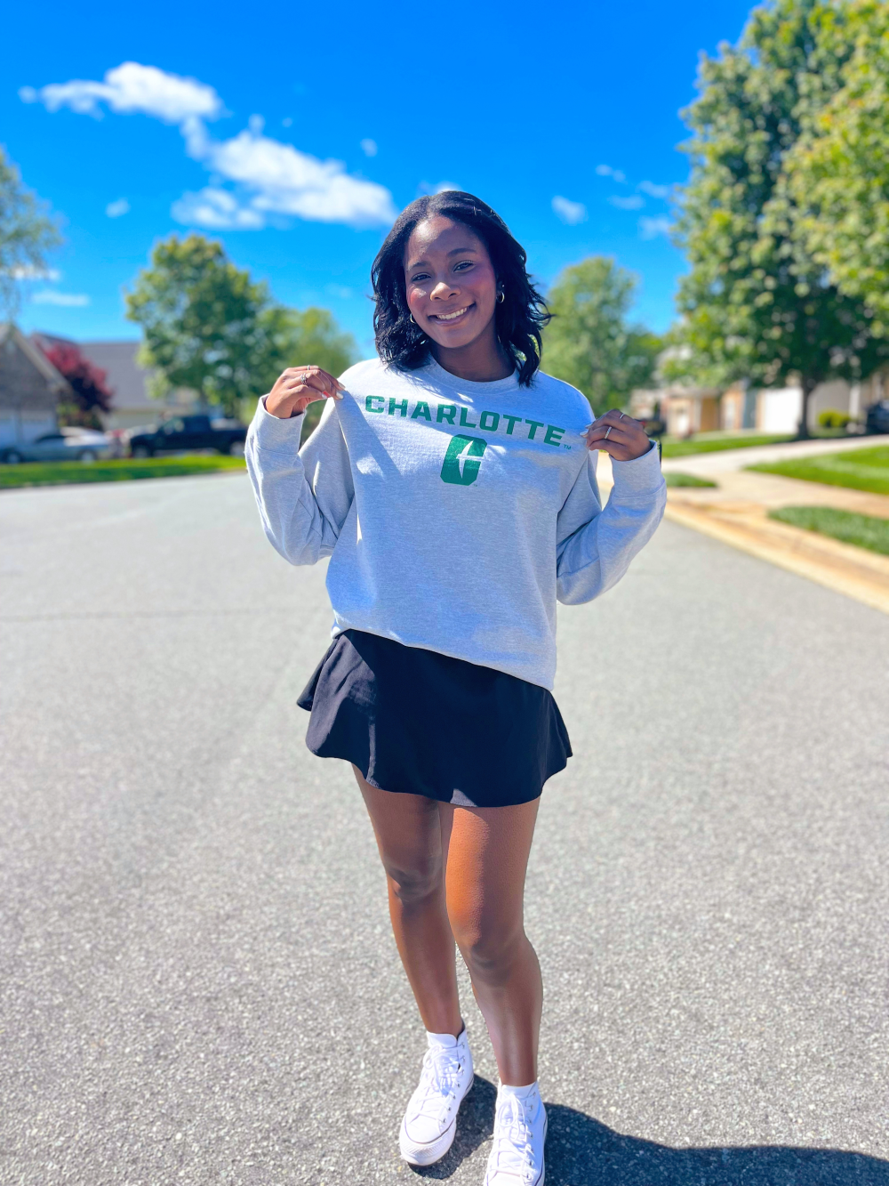 Frink shows off her UNC Charlotte sweatshirt outside on Decision Day.