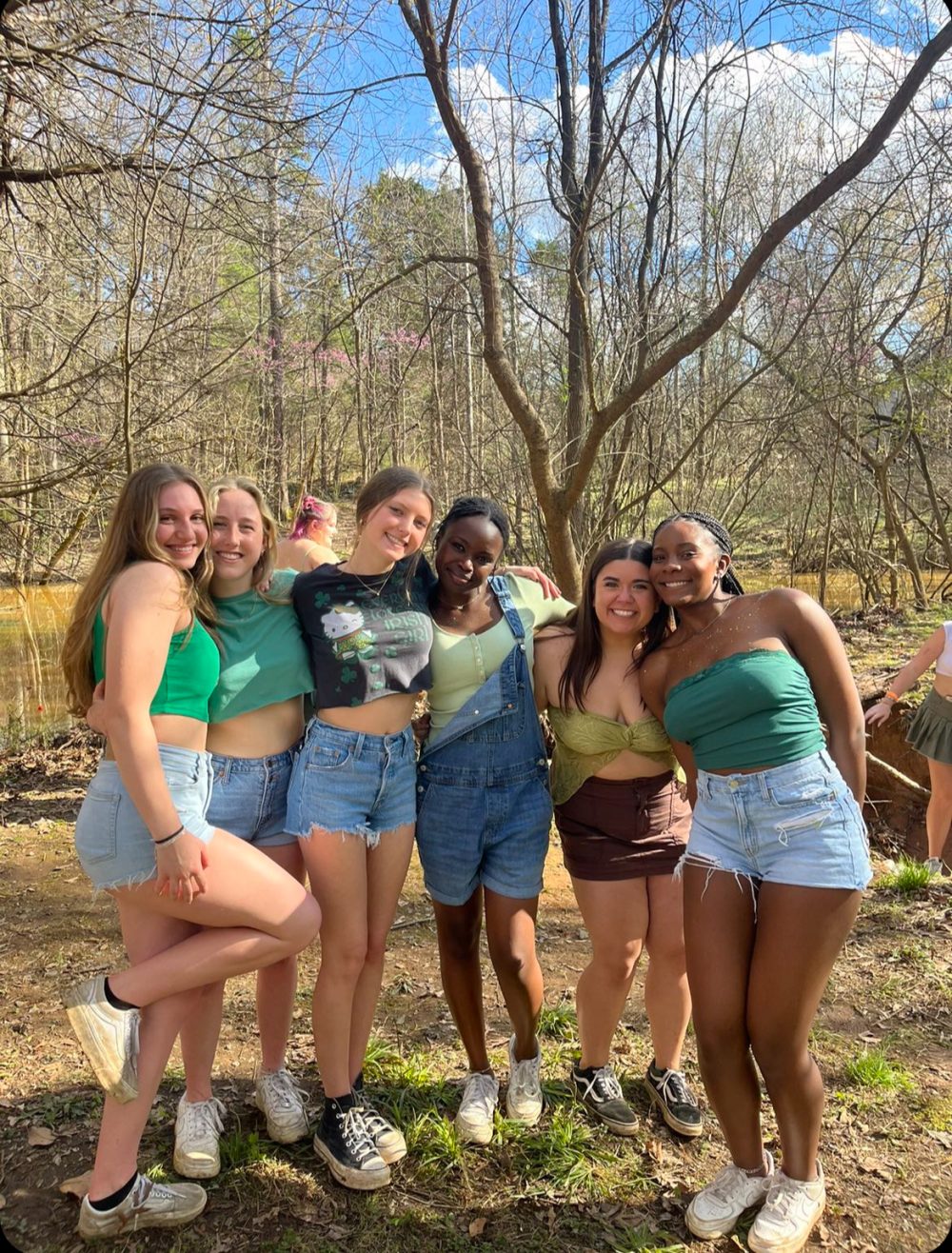 Frink and friends posing in UNC Charlotte green attire.
