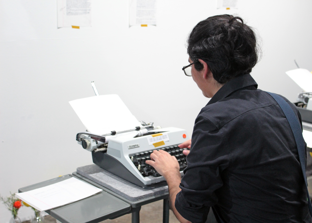 Barrios types on the typewriter.