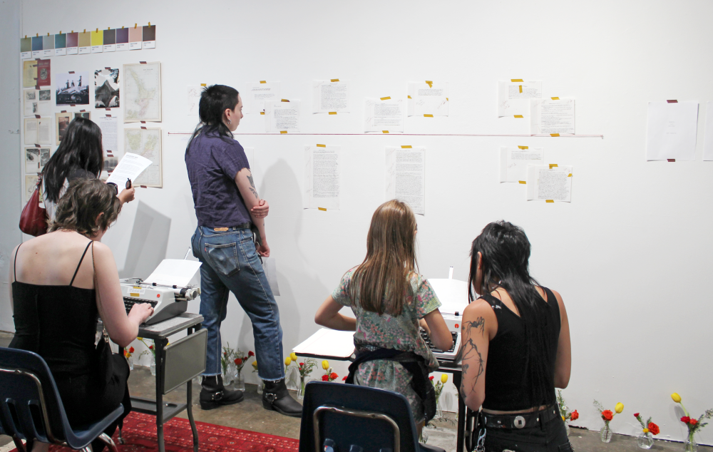 Attendees type on typewriters and read the first drafts on the galler wall.