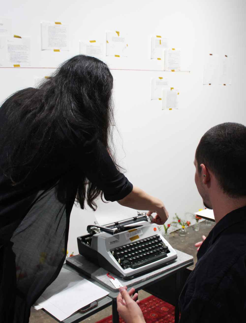 Hussey helps Beets refill the typewriter paper.